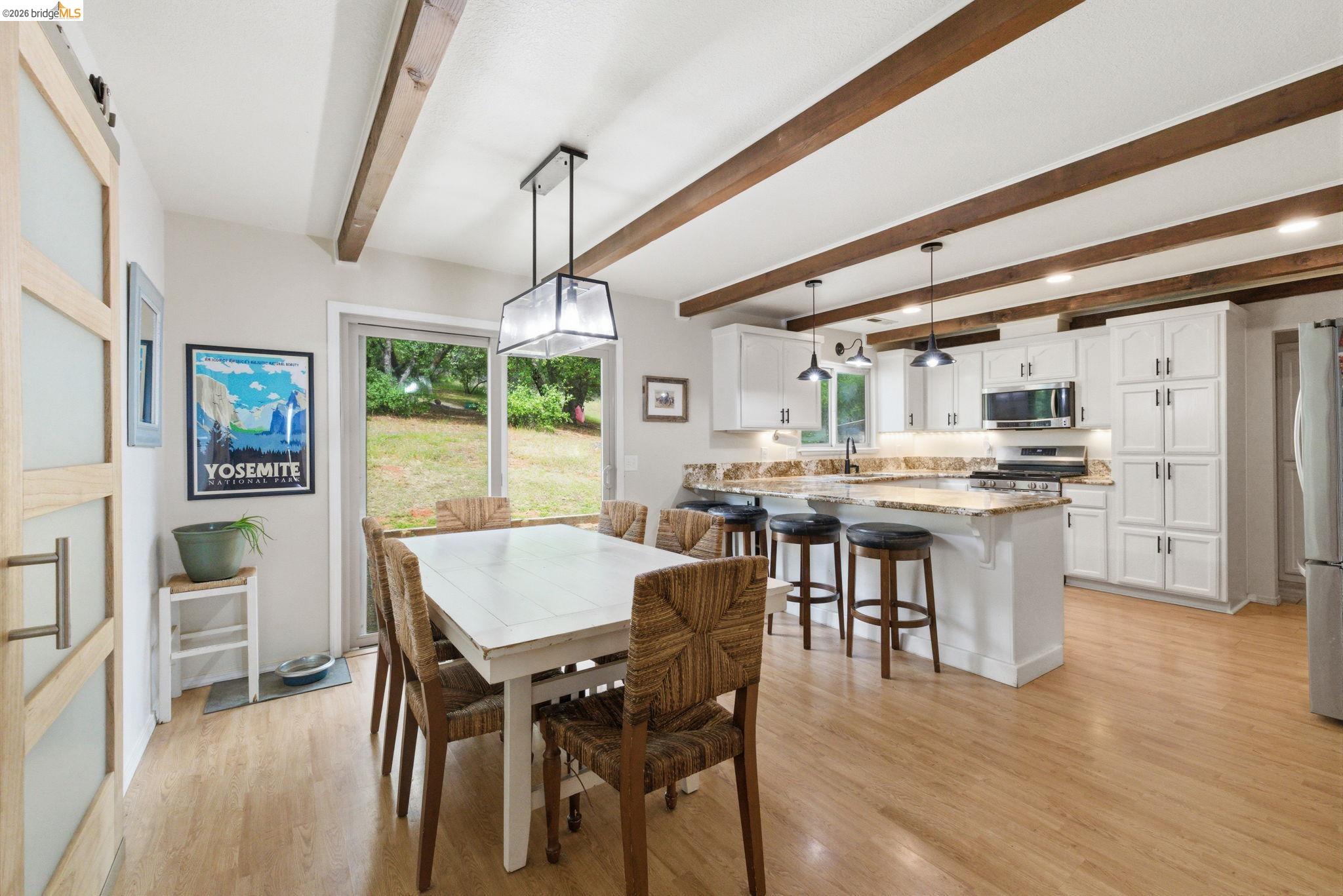16860 Buckhorn Mountain Road Sonora, CA 95370 - Photo 27 of 46 Dining space featuring light wood-style floors and beamed ceiling