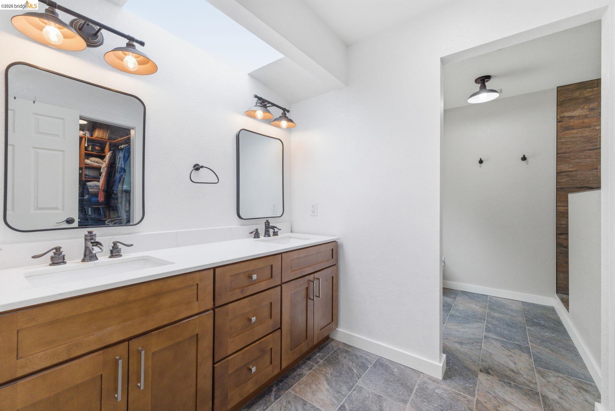 16860 Buckhorn Mountain Road Sonora, CA 95370 - Photo 9 of 46 Full bath featuring double vanity, dark stone finish floors, and a walk in shower