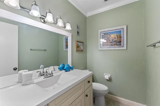 a bathroom with a sink vanity mirror and toilet