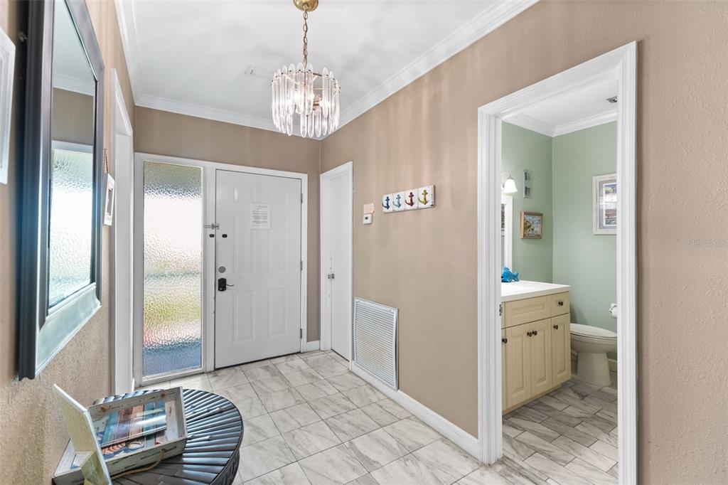 60 Gulf Boulevard, Unit 402 Indian Rocks Beach, FL 33785 - Photo 3 of 31 a spacious en suite bathroom with a granite countertop sink a mirror and a shower