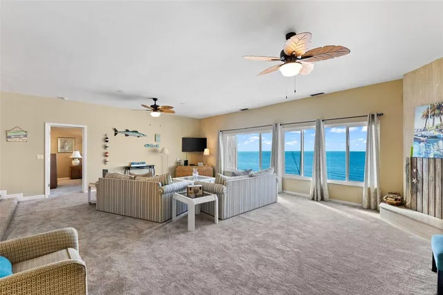 a living room with furniture ceiling fan and a rug