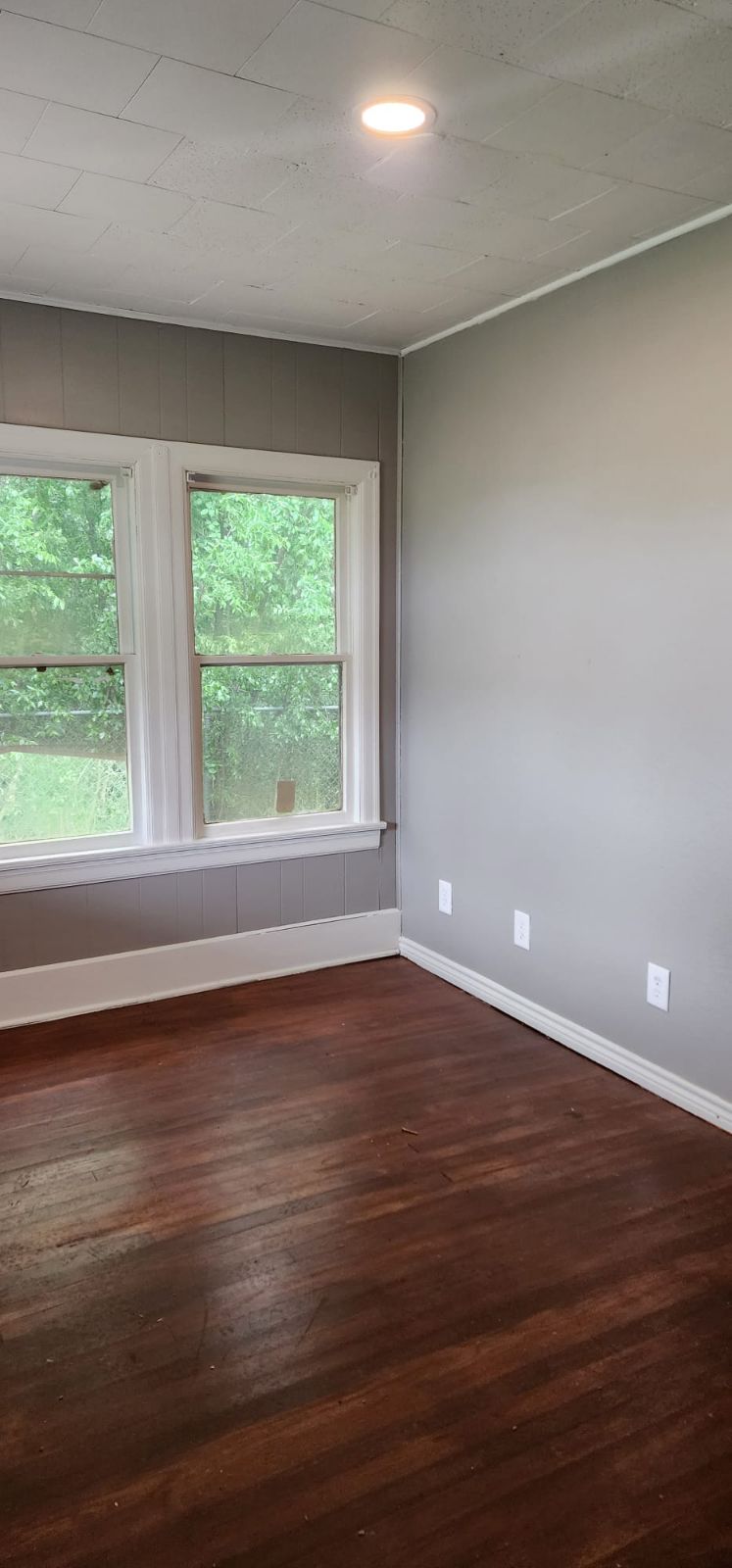 18327 Blake Manor Road, Unit A Manor, TX 78653 - Photo 15 of 21 Unfurnished room featuring dark wood-style flooring and plenty of natural light
