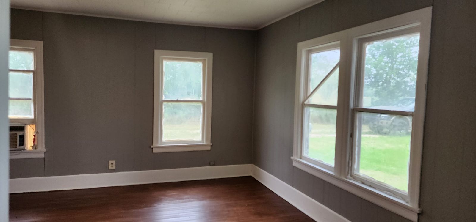 18327 Blake Manor Road Manor, TX 78653 - Photo 8 of 21 a view of an empty room with wooden floor and a window