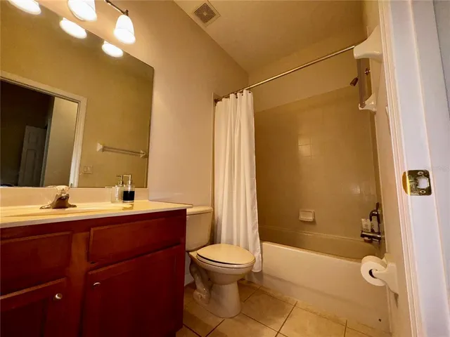 a bathroom with a double vanity sink toilet mirror and shower