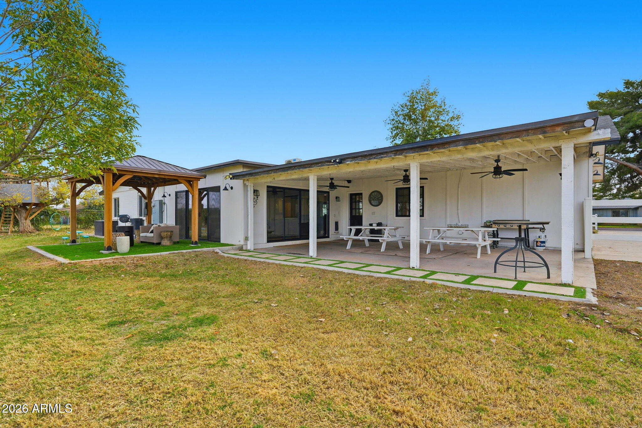 2858 East Redfield Road Gilbert, AZ 85234 - Photo 55 of 60 a view of a house with swimming pool and a table and chairs