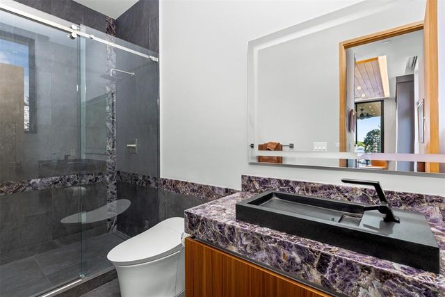 a view of balcony with a red door and wooden floor