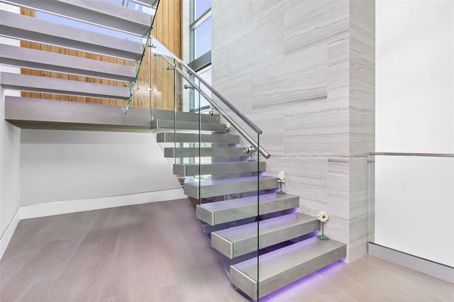 a living room with a large tree and a chandelier