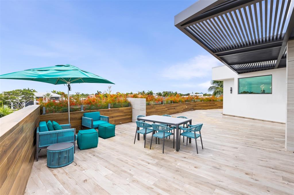 34 Minnetonka Road Sea Ranch Lakes, FL 33308 - Photo 51 of 89 an outdoor space with furniture and umbrella