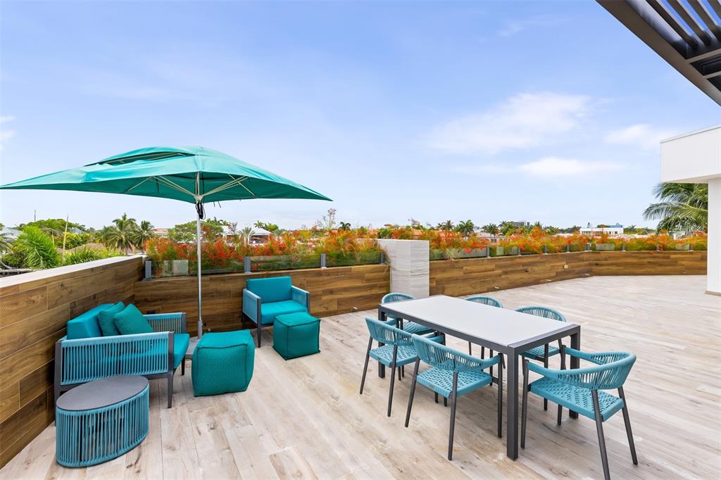 34 Minnetonka Road Sea Ranch Lakes, FL 33308 - Photo 52 of 89 a view of a terrace with furniture and umbrella