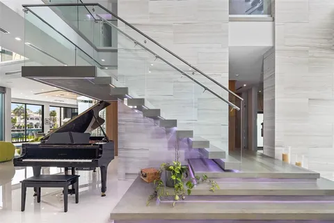 a kitchen with stainless steel appliances kitchen island granite countertop a table chairs sink and cabinets