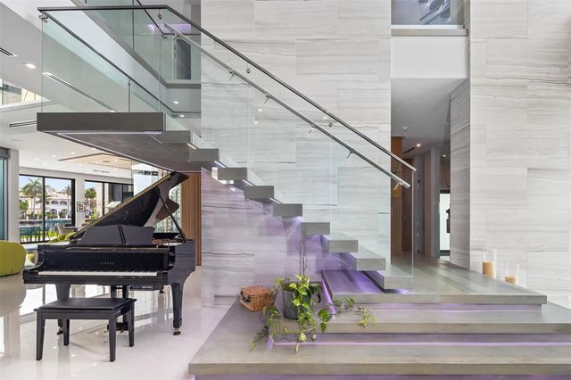 a kitchen with stainless steel appliances kitchen island granite countertop a table chairs sink and cabinets