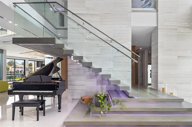 a kitchen with stainless steel appliances kitchen island granite countertop a table chairs sink and cabinets