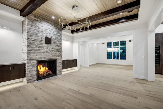 a view of an empty room with a fireplace and a window