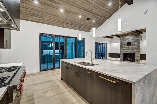 a kitchen with kitchen island a sink and a stove
