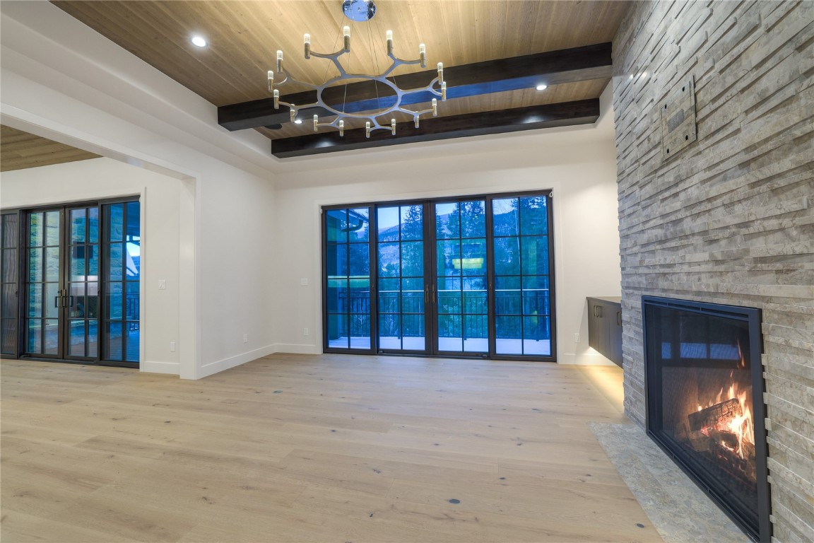 90 West Trade Court Keystone, CO 80435 - Photo 14 of 50 a view of an empty room with a fireplace and a chandelier