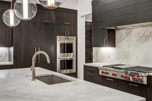 a kitchen with granite countertop a stove and a sink