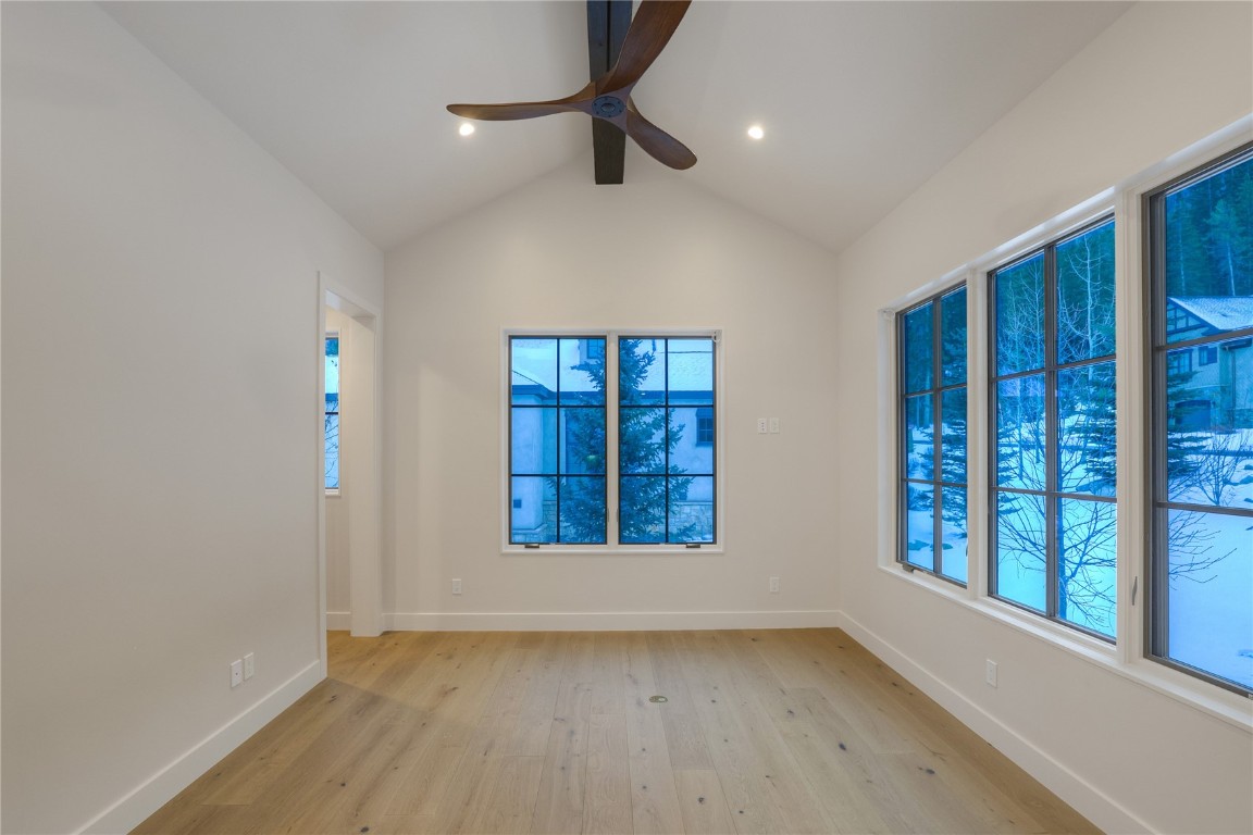 90 West Trade Court Keystone, CO 80435 - Photo 31 of 50 Empty room featuring light wood-style floors, lofted ceiling, and ceiling fan
