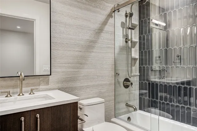 a bathroom with a sink toilet and shower