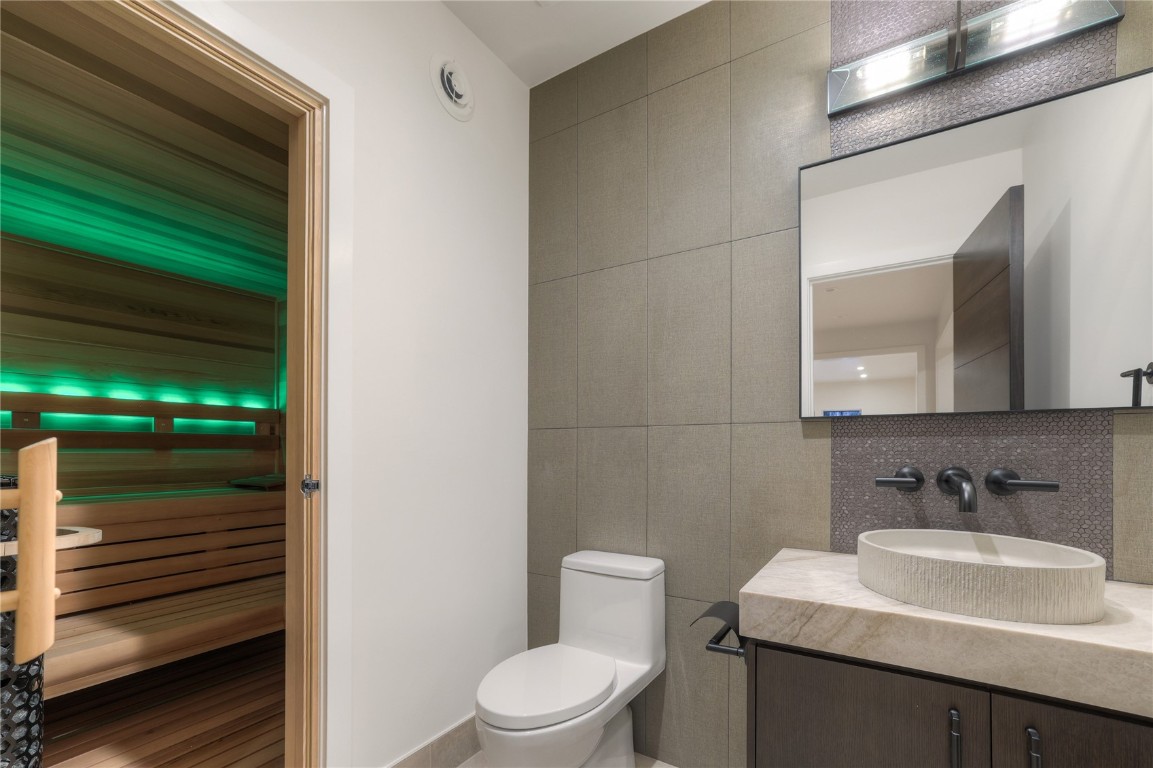 90 West Trade Court Keystone, CO 80435 - Photo 40 of 50 a bathroom with a toilet sink vanity and mirror
