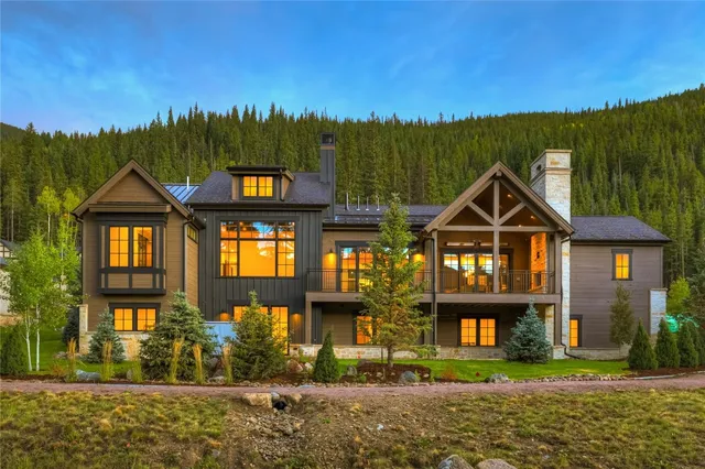 a view of a house with a yard balcony and a slide