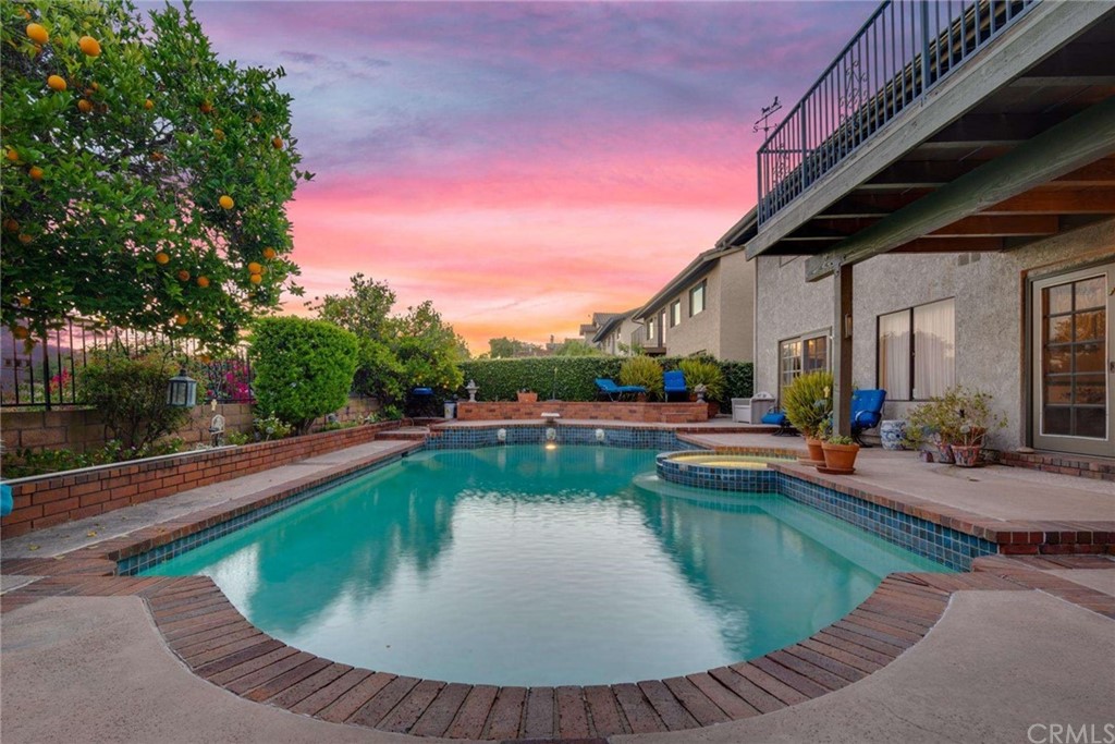 3750 Valley Lights Drive Pasadena, CA 91107 - Photo 2 of 55 a view of swimming pool that has lawn chairs with plants and trees