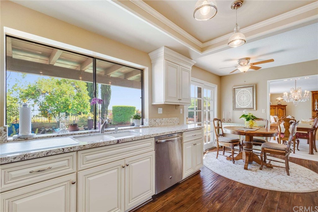 3750 Valley Lights Drive Pasadena, CA 91107 - Photo 23 of 55 a dining hall with stainless steel appliances granite countertop a stove a sink dishwasher and white cabinets with wooden floor