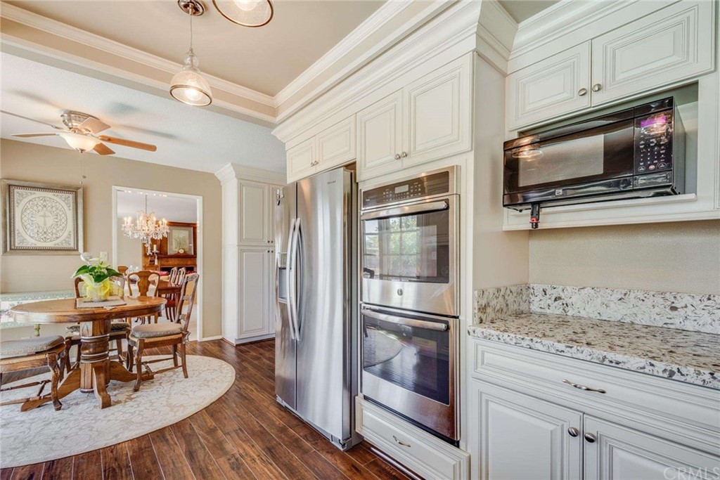 3750 Valley Lights Drive Pasadena, CA 91107 - Photo 24 of 55 a kitchen with stainless steel appliances granite countertop a refrigerator microwave and wooden floor