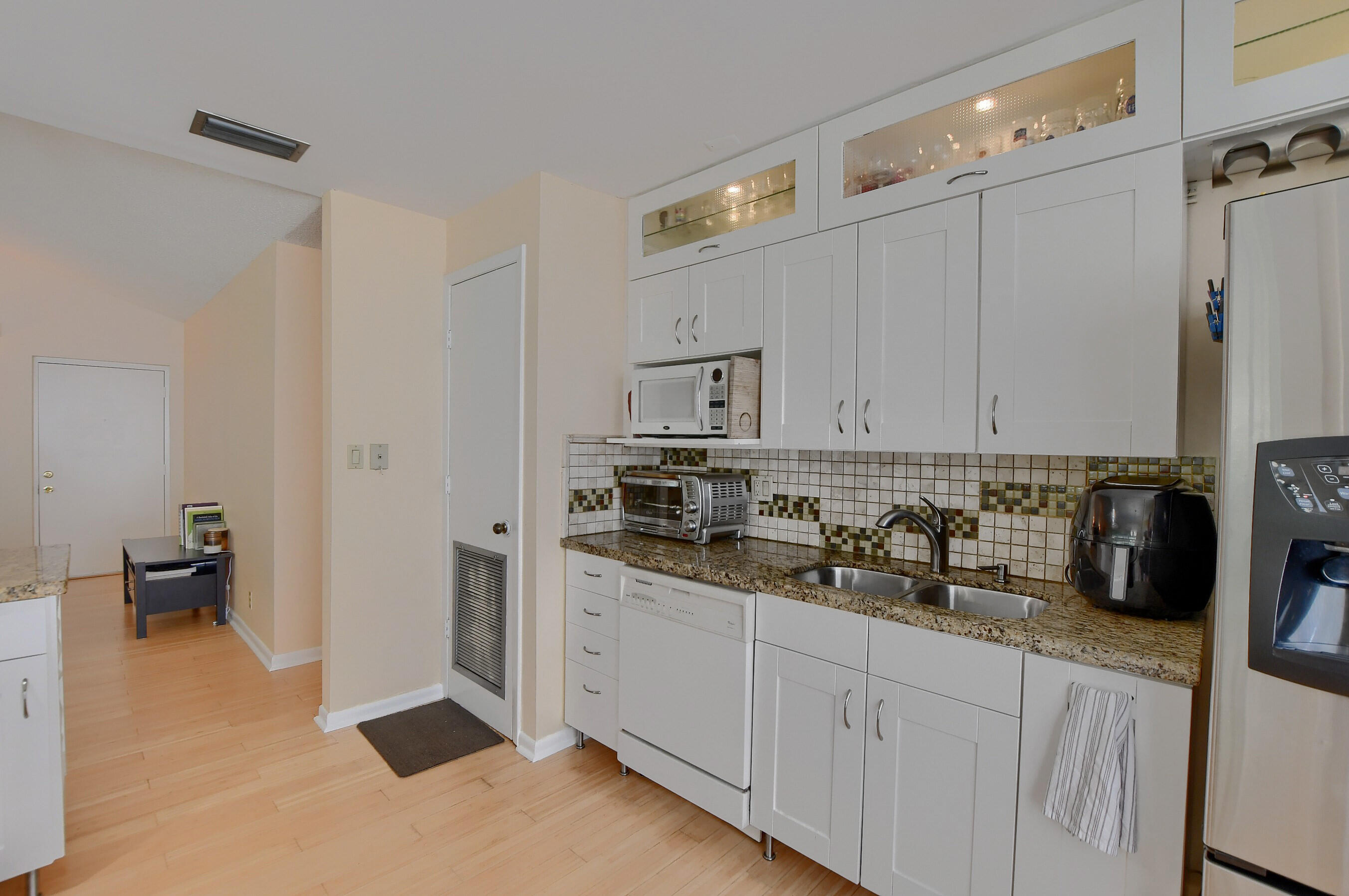 6237 Old Court Road, Unit 203 Boca Raton, FL 33433 - Photo 12 of 34 a kitchen with stainless steel appliances white cabinets and a sink