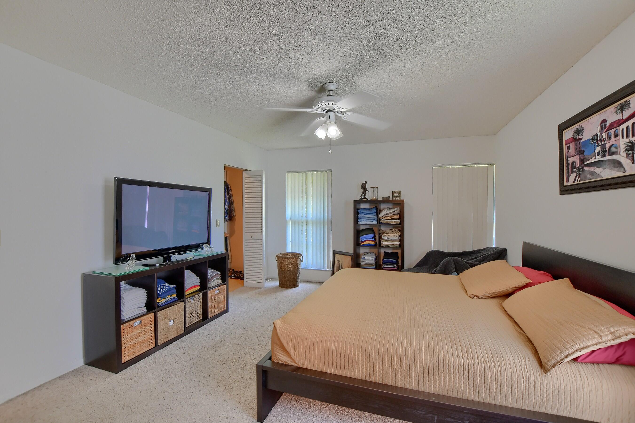6237 Old Court Road, Unit 203 Boca Raton, FL 33433 - Photo 15 of 34 a bedroom with a bed and dresser