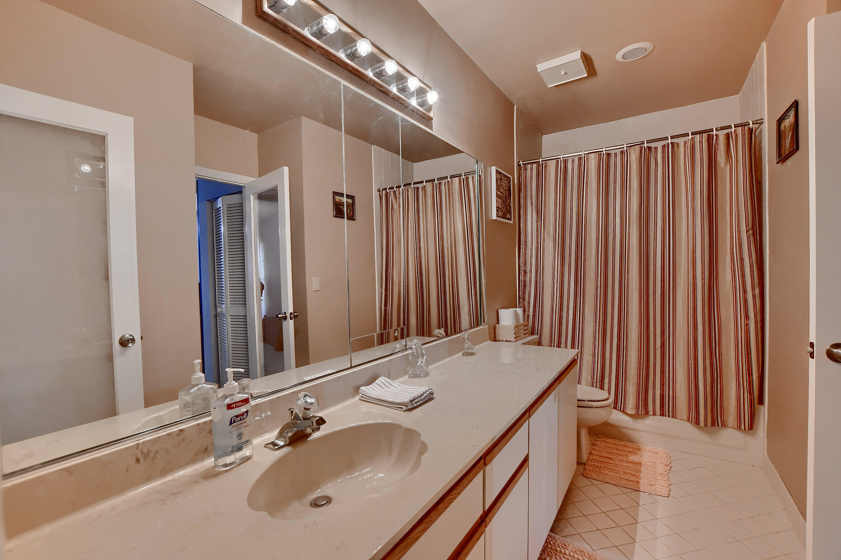 6237 Old Court Road, Unit 203 Boca Raton, FL 33433 - Photo 20 of 34 a bathroom with a double vanity sink and a mirror