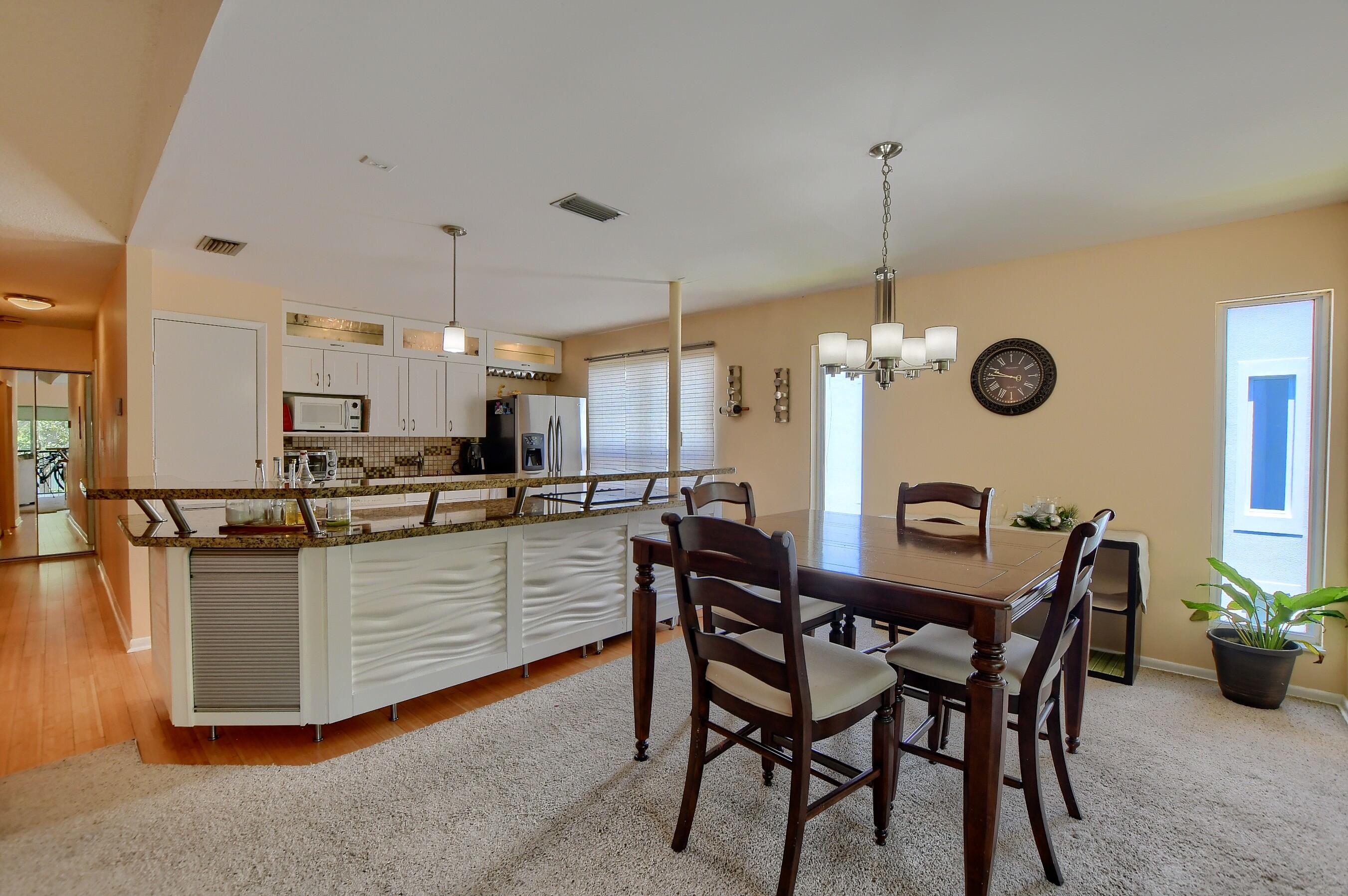 6237 Old Court Road, Unit 203 Boca Raton, FL 33433 - Photo 8 of 34 a kitchen with stainless steel appliances granite countertop a table chairs stove and white cabinets
