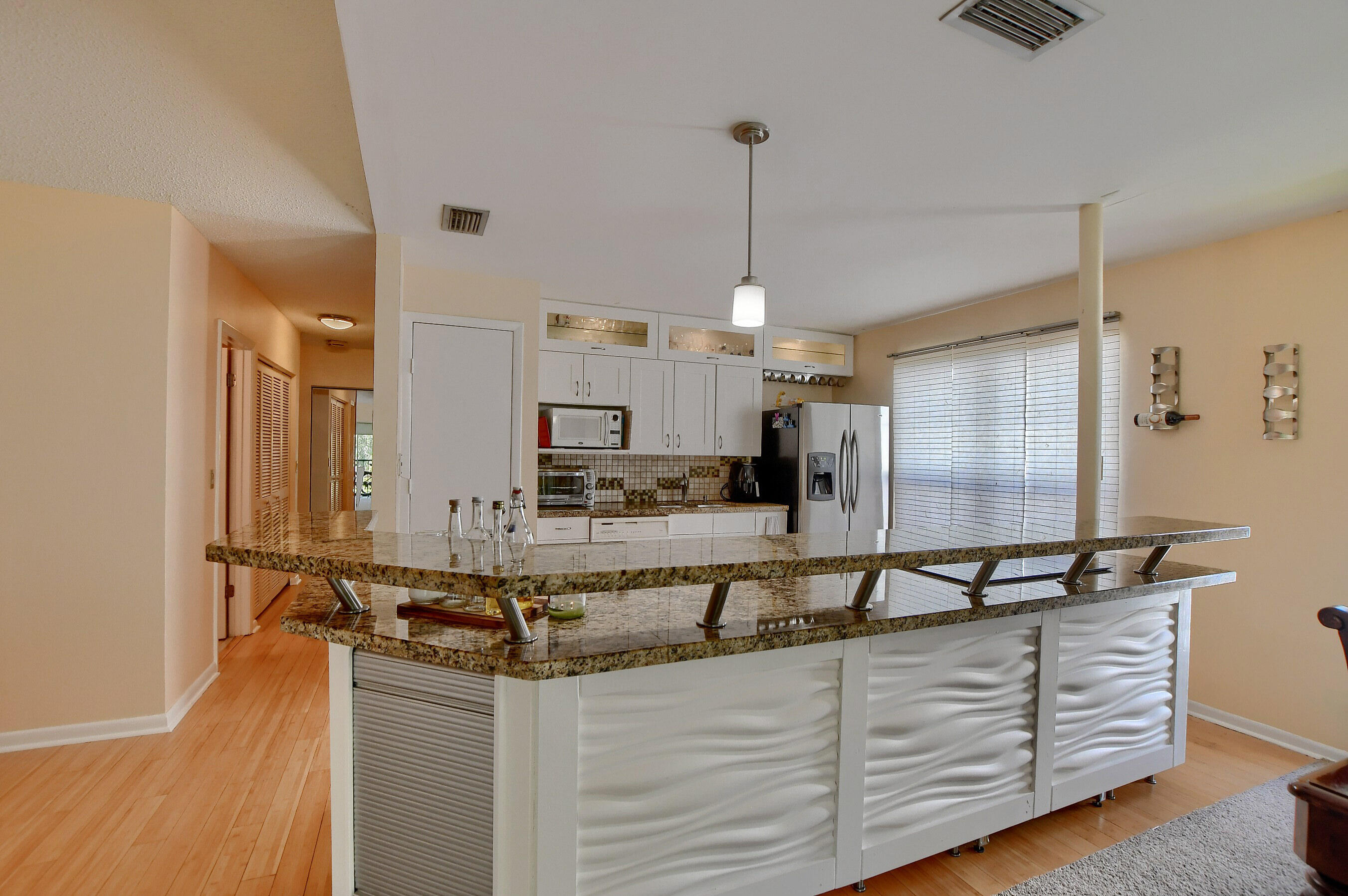 6237 Old Court Road, Unit 203 Boca Raton, FL 33433 - Photo 9 of 34 a view of a kitchen with stainless steel appliances granite countertop a sink and a wooden floor