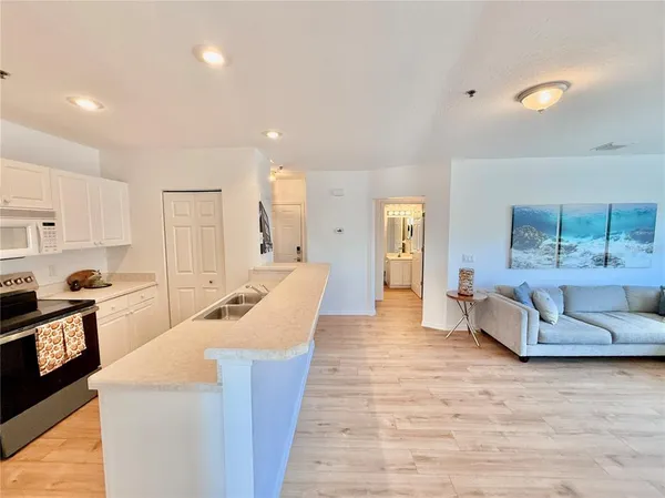 a kitchen with a sink stove top oven and cabinets