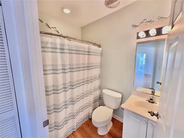 a spacious bedroom with a bed and a cabinets