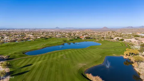 an aerial view of a house with a yard and lake view