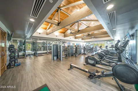 a living room with furniture and a painting on the wall