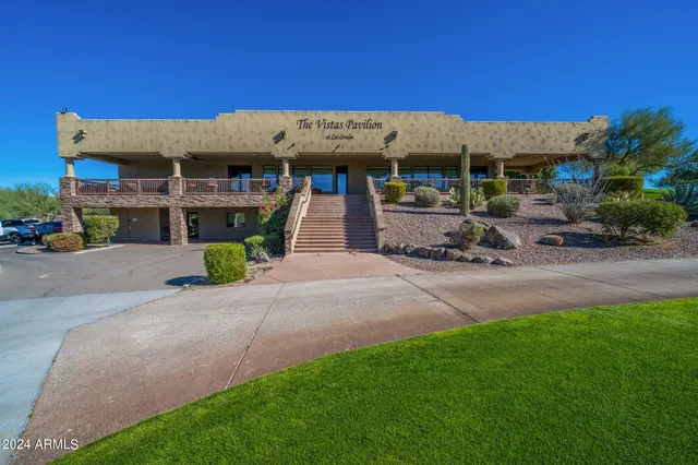 a sign board with the view of tall trees
