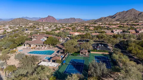 an aerial view of a house with a mountain