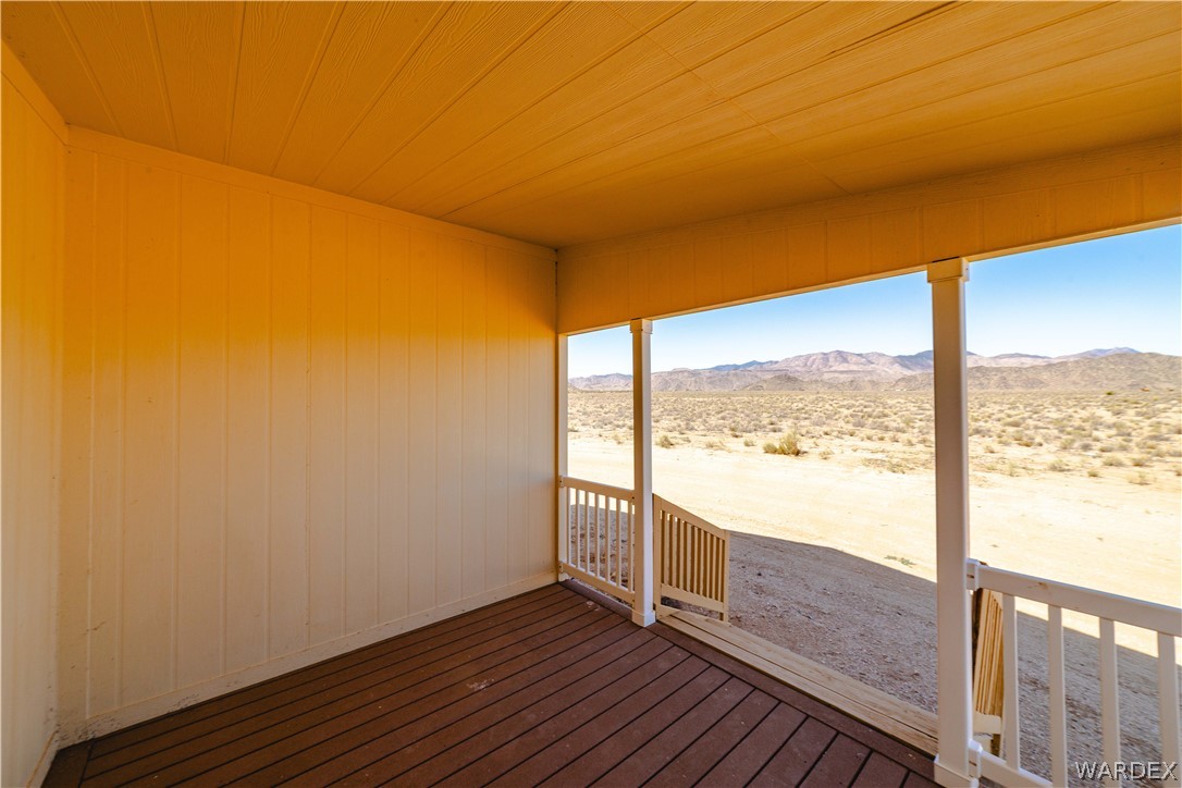 3190 East Pepper Tree Road Kingman, AZ 86409 - Photo 42 of 67 a view of an empty room with wooden floor and a window
