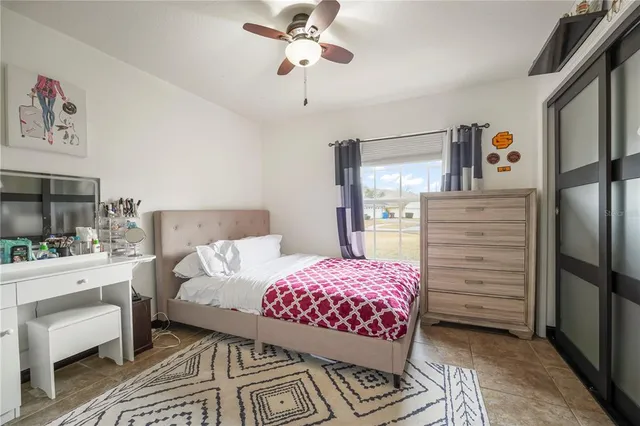 a bedroom with a bed a chandelier and closet