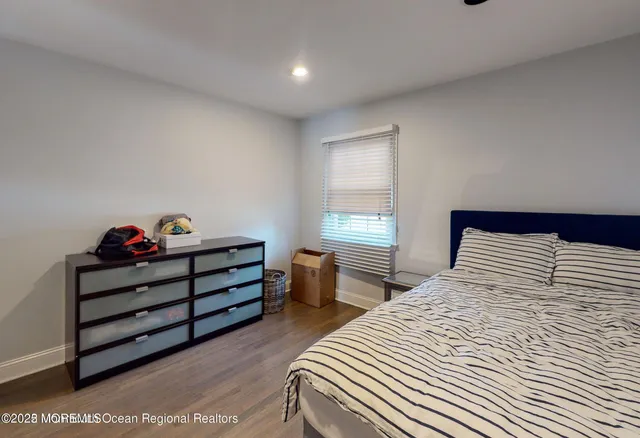 a spacious bathroom with a granite countertop sink a toilet and a mirror