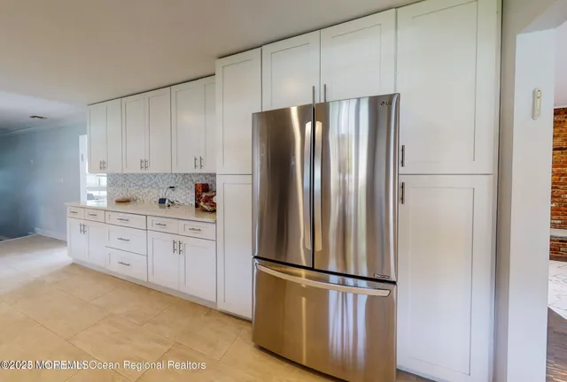 a kitchen with stainless steel appliances a refrigerator sink and cabinets
