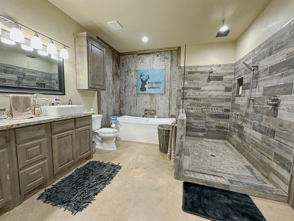 1990 Jim Harry Loop Sunset, TX 76270 - Photo 9 of 39 a bathroom with a sink a toilet and shower