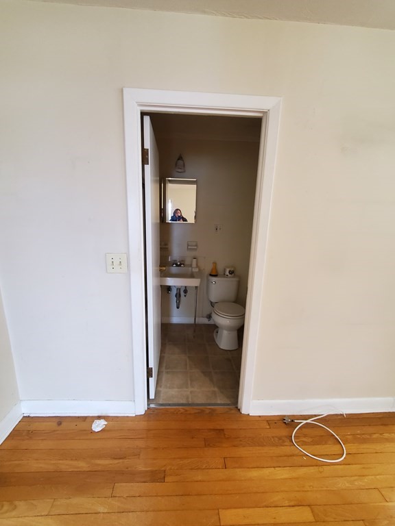 39 Beacon Street Fall River, MA 02721 - Photo 5 of 36 a view of a room with wooden floor and a bathroom