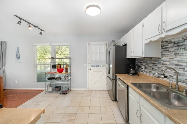 a kitchen with a sink cabinets and appliances