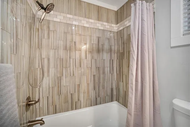 a bathroom with a shower curtain and a curtain