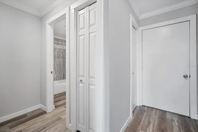 a view of a hallway with wooden floor