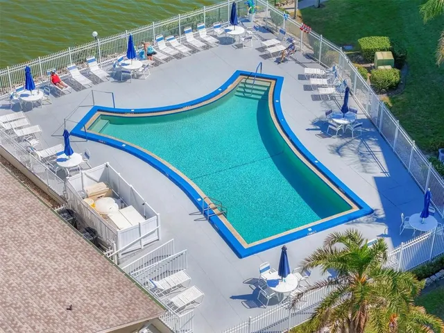 a swimming pool with outdoor seating and yard