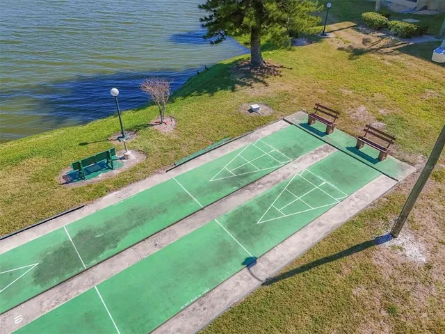 a view of a lake with boats and trees in the background