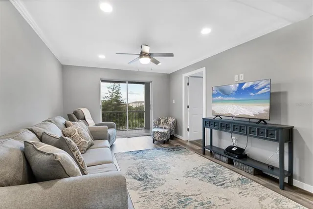 a living room with furniture a rug and a flat screen tv